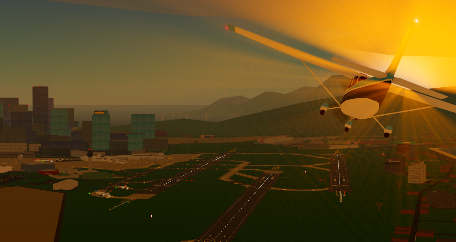Aircraft approaching an illuminated airport at sunset